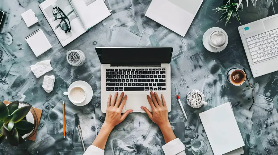 Bovenaanzicht handen op laptop voor copywriting opdracht